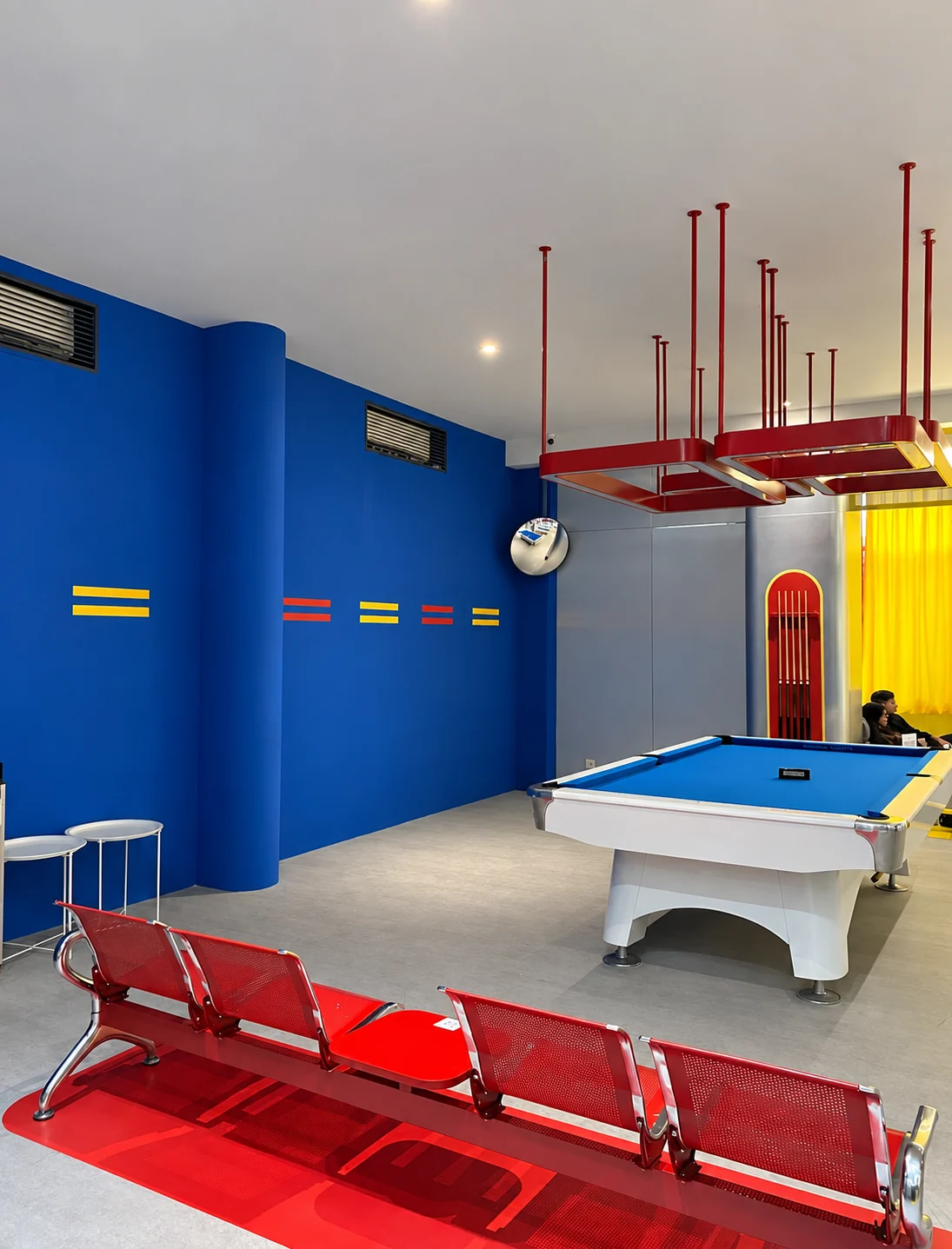 Red chairs and blue billiard tables at the HQ